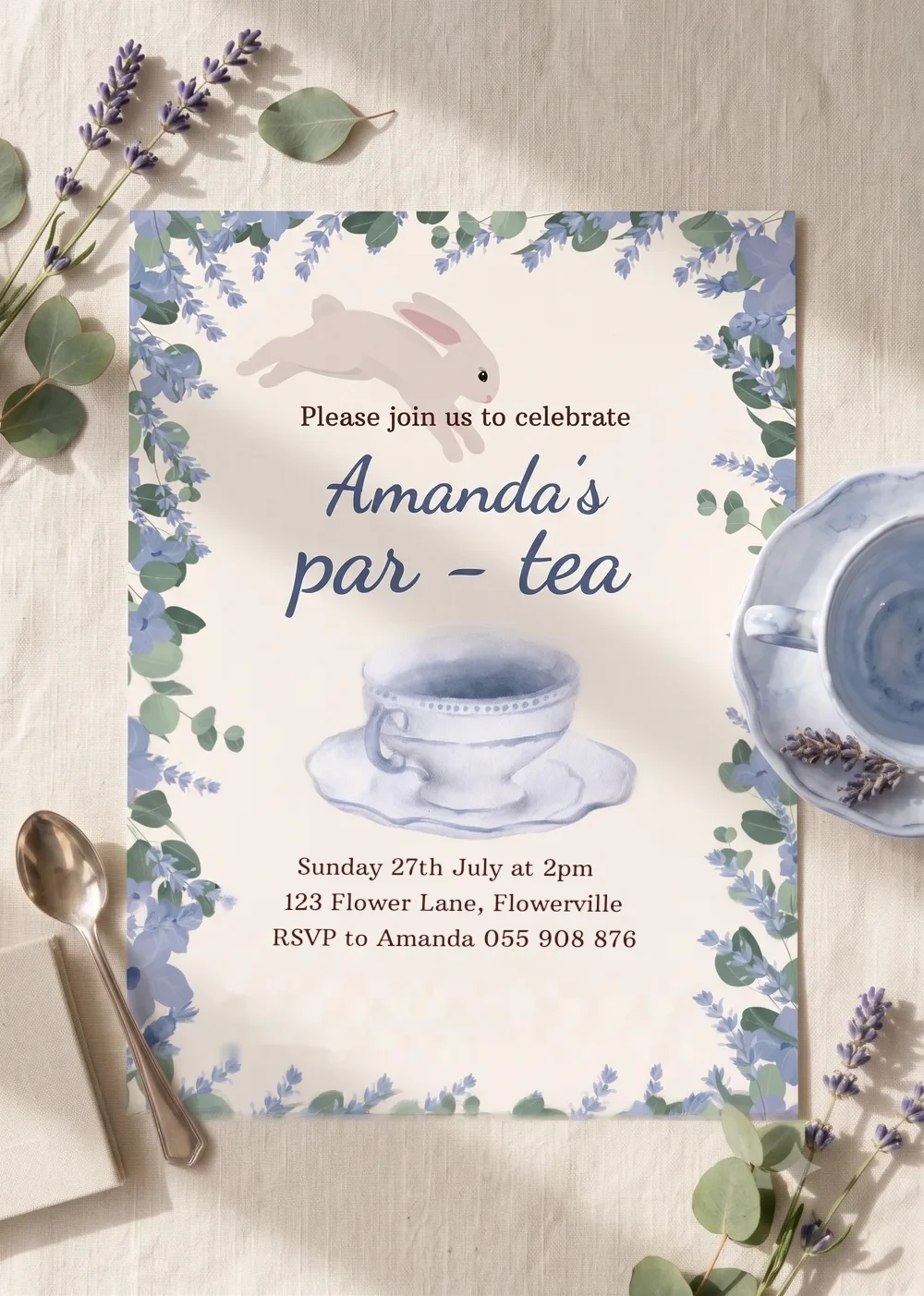 The printed Par-tea invitation on cream linen among lavender sprigs, eucalyptus and a blue teacup